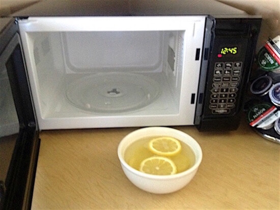 un micro-ondes avec un bol d'eau et des rondelles de citron